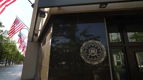Camera pulling away from the seal on front of J Edgar Hoover FBI headquarters Stock Footage 212630977