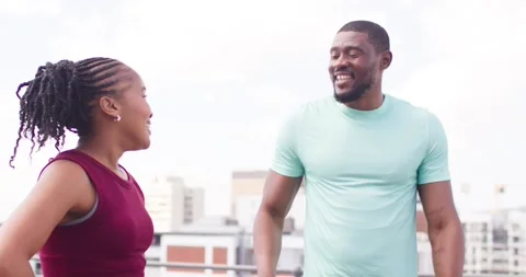 Camera pulling back, African American couple celebrating workout, high-fiving on Stock Footage 340654528
