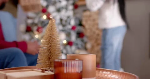 Camera pulling back, African American family decorating frosted tree at home, Stock Footage 342066350