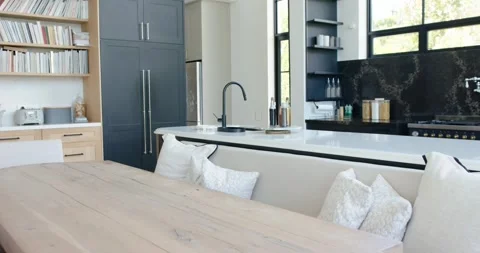 Camera is pulling back and panning right to reveal light wood table, bench, Stock Footage 339272282
