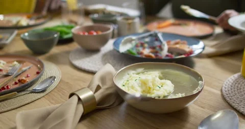 Camera is pulling back, bowl of mashed potatoes staying centered while utensils Stock Footage 337305946