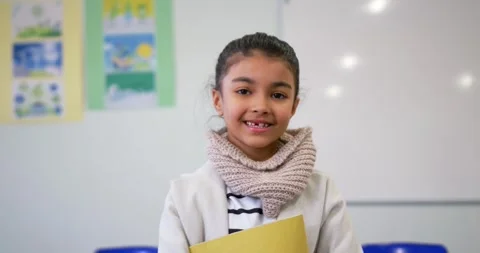 Camera pulling back causing schoolgirl holding yellow folder and scarf looking Stock Footage 340655588
