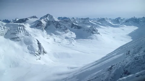 Camera pulling back from a helicopter window. Winter mountain range. Stock Footage 169193761
