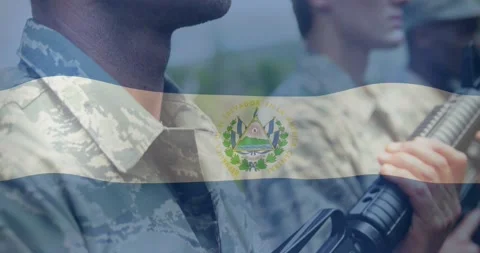 Camera pulling back lead soldier holding rifle El Salvador flag overlay rippling Stock Footage 328685991