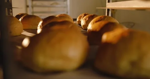Camera is pulling back as parchment tray is sliding, revealing dozen golden Stock Footage 345072673