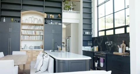Camera is pulling back, revealing double-height kitchen interior, showcasing Stock Footage 345064010