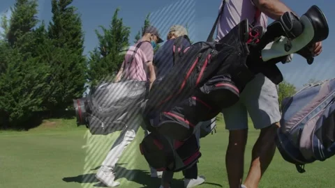 Camera pulling back revealing four golfers walking fairway with bags, trolley, Stock Footage 331176110