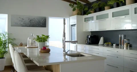 Camera is pulling back, stainless-steel pull-down spring faucet is anchoring Stock Footage 336658576