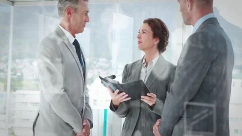 Camera pulling back woman briefing two peers in suits at windows holding black Stock Footage 333902946