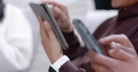 Camera pulling back as woman holding blue smartphone is tapping and scrolling to Stock-Footage 345607861