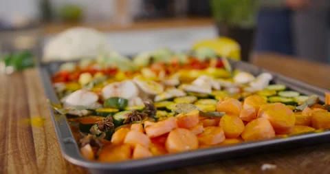 Camera is pulling focus, revealing seasoned vegetable tray on wood board ready Stock Footage 339232468