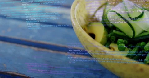 Camera pulling revealing yellow bowl on blue table code scrolling veg focusing Stock Footage 323371114