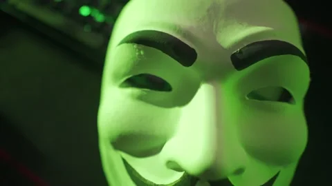 Camera Pulls Away From Guy Fawkes Mask on LED Keyboard Stock Footage 132839876