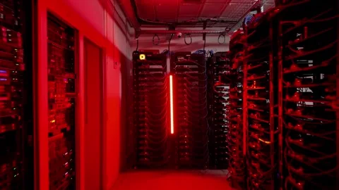 Camera pulls back through data center with flashing blue and red emergency .. Stock Footage 339397138