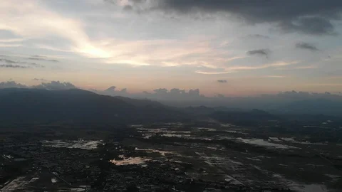 The camera is pursued by a biker on the fields flooded with water in Vietnam Video stock 100188873