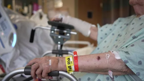 Camera pushes in from view of elderly woman with broken arm and black eye Stock Footage 287730222