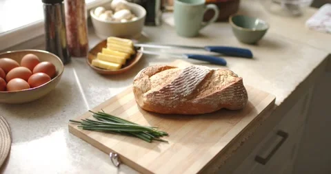 Camera is pushing in and focusing on loaf of crusty bread on cutting board for Stock Footage 337731252