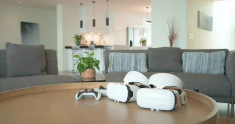 Camera pushing in, panning right, highlighting VR headsets and controller on Stock Footage 344325673