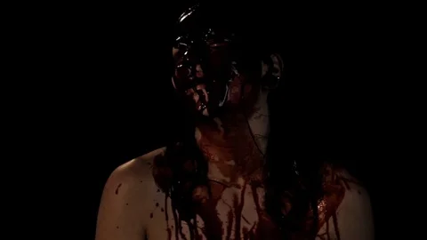 Camera quick pan to bloodied person, from darkness and back to it Stock Footage 99072581