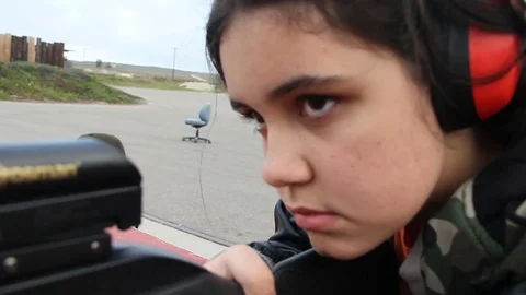Camera quickly moves around young kid aiming gun Stock Footage 113912876