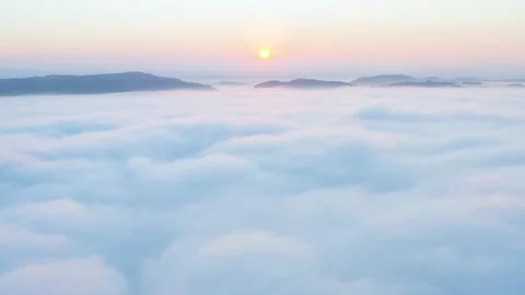 Camera is raising above from the thick fog above the beautiful ocean of clouds Stock Footage 152881925