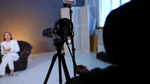 Camera Recording Interview Subject In Studio Setup. Camera on tripod records Video stock 334812849
