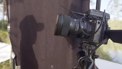 Camera recording lighting tutorial with shadow of boy on black negative fill 動画素材 318651162