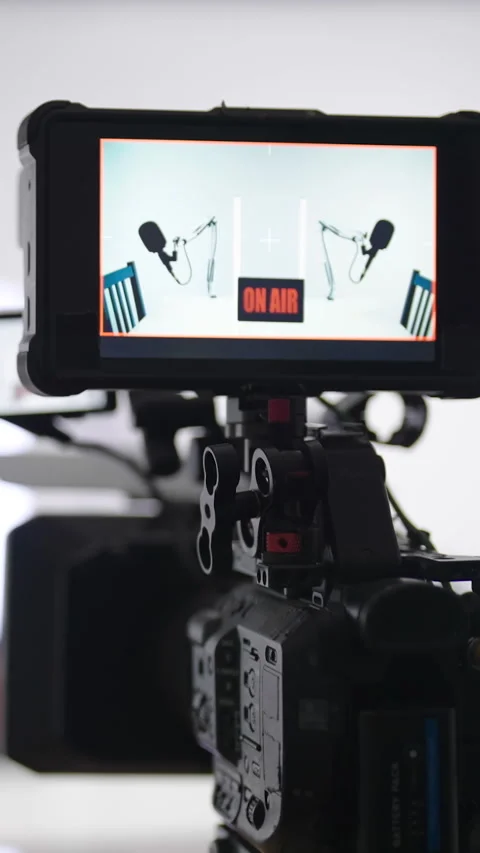 Camera recording white podcast studio with led tubes zoom out of monitor Stock Footage 324974058