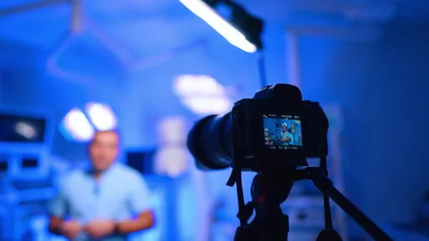 Camera Records Doctor Vlog With Blue Clinic Background Stock Footage 333651625