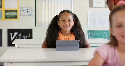 Camera refining focus, classmates in classroom watching youth female student Stock Footage 334924162