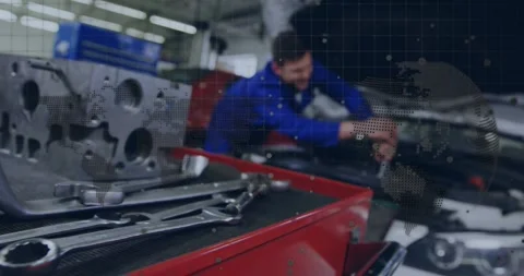 Camera refocus showing tech reaching engine, doing repair beside red cart, Stock Footage 329904358