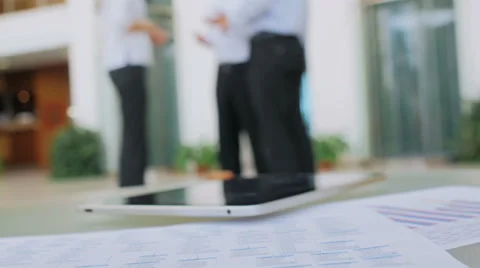 The camera removes the close plan a table on which papers and the tablet lie Stock Footage 57457747