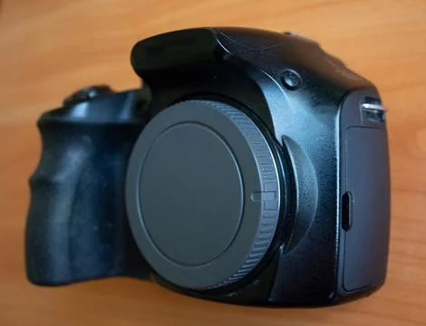 Camera resting on a wooden surface Stock Photos