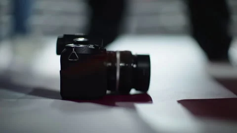 The camera rests on a white surface. Close-up of the camera and lens. Stock Footage 255433776