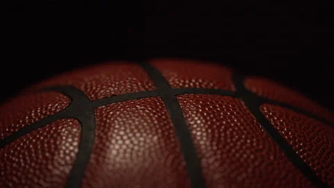 Camera reveals off centre symmetry close up pattern of lines on a basketball Stock-Footage 135592005