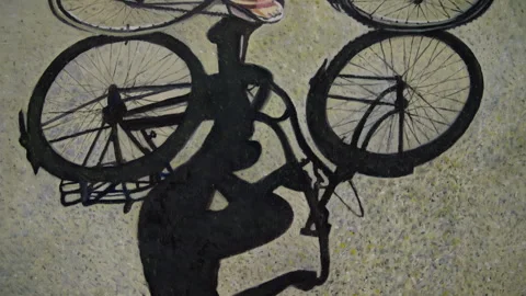 Camera Reveals Detail of Bicycle Shadow Painting Stock Footage 346269265