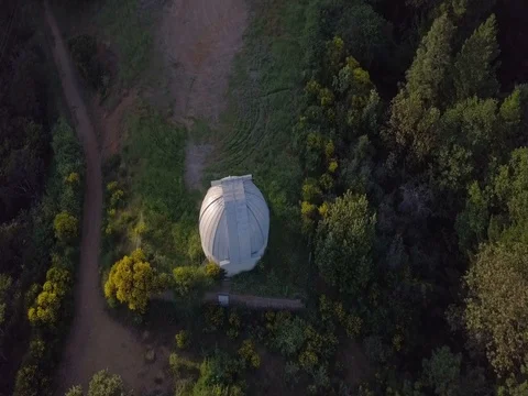 Camera reveals observatory surrounded by fields and forests Stock Footage 75459562