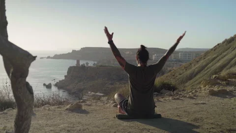 Camera Reveals Young Strong Man Stretching and Doing Yoga in Nature Stock Footage 137947043