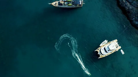 Camera revolves around the turns of jet ski that floats on a curve among the Stock Footage 116904217