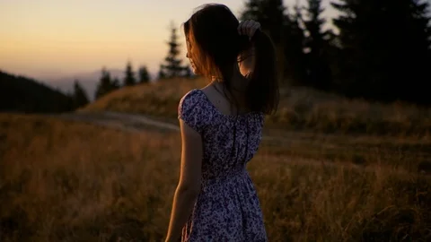 Camera revolves around young beautiful woman in long dress straightens her hair Stock Footage 117711262