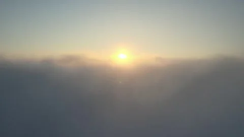 Camera rises above clouds, golden sunrise. Flying above the clouds illuminated Vídeo Stock 249372901