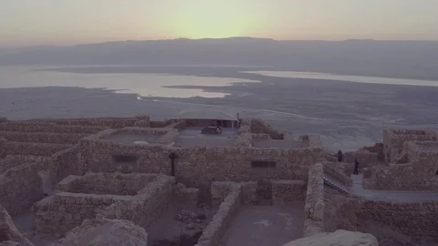 Camera rises above rocks to show ancient city near water 2 Stock Footage 82836272