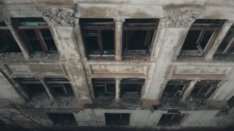 Camera rises up along abandoned building on cloudy day Stock Footage 152338287
