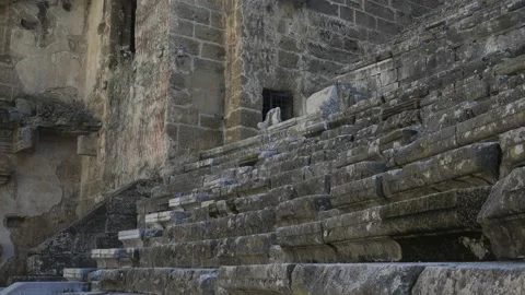 The camera rises up along the steps of the ancient amphitheater. Stock Footage 224065990