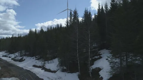 Camera rises and reveals wind turbines in wilderness Stock Footage 130304926