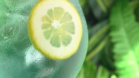 Camera rises from base to top of dewy glass with blue cocktail and lemon slice, Stock Footage 306283180