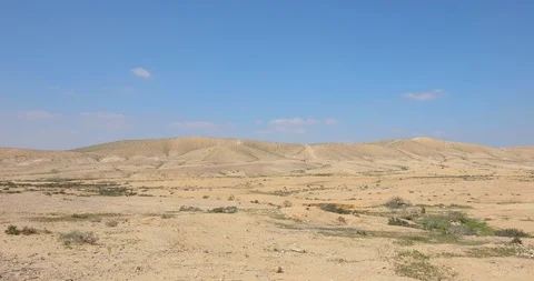 Camera rises from ground to far hills in desert Stock Footage 117754456