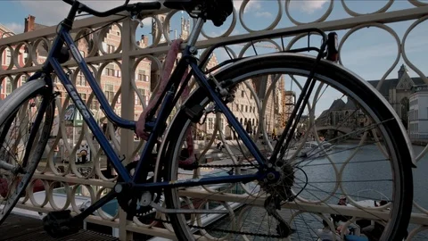 Camera rises jib style behind from behind bike to reveal Graslei Stock Footage 90332029