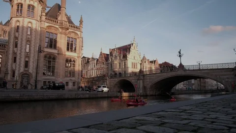 Camera rises jib style in front of St Michael’s  as Kayakers pass under Stock Footage 90332243