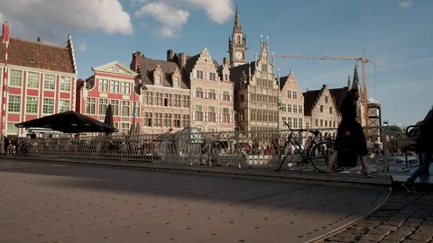 Camera rises jib style to show cyclists crossing Grasbrug Bridge Ghent Stock Footage 90332072